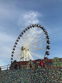 Low angle view of ferris wheel against sky