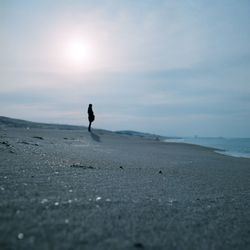 Silhouette of man standing on beach