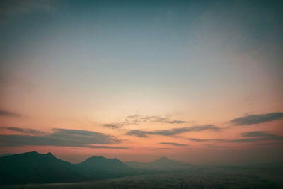 Scenic view of silhouette mountains against sky during sunset