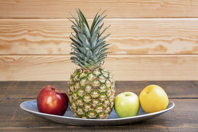 Close-up of apples in plate on table