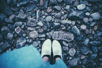 Low section of woman standing on rocks