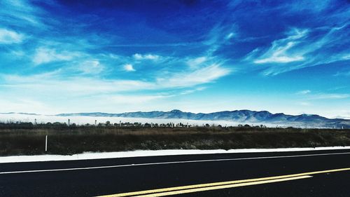 Scenic view of mountains against cloudy sky