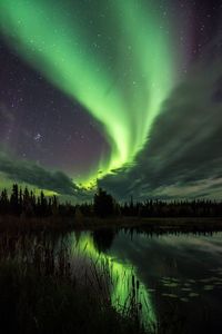 Scenic view of lake against sky at night