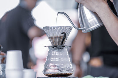 Close-up of hand pouring coffee