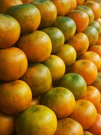 Juicy oranges stacked neatly