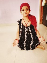 Portrait of young woman standing on tiled floor at home