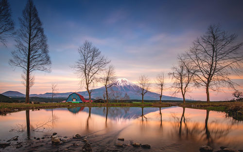 Scenic view of lake against sky at sunset