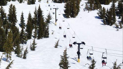 High angle view of ski lift over snowcapped mountain