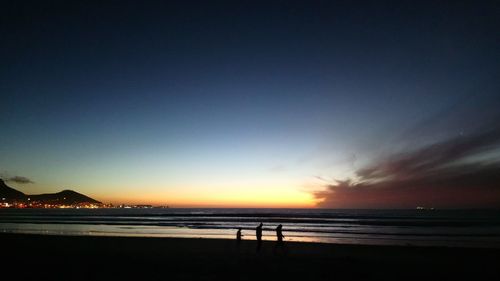 Scenic view of beach against sky during sunset