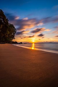 Scenic view of beach against sky during sunset