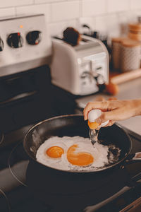 Midsection of man having food in kitchen