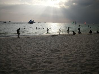 People on beach against sky