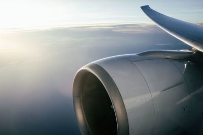 Cropped image of airplane against cloudy sky