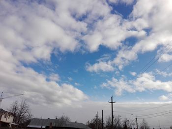 Low angle view of electricity pylon against sky