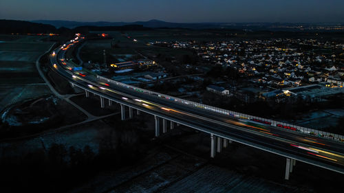 High angle view of illuminated buildings in city at night