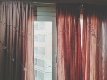  sunlight peeking through pink curtains
