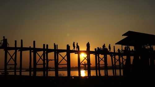 Silhouette people against sky during sunset