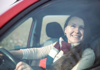 Portrait of young woman in car