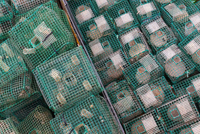Stacked green plastic traps for octopus and crab close up