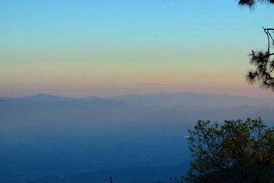 Scenic view of silhouette mountains against sky at sunset