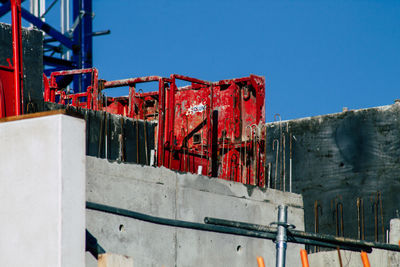 Low angle view of old machinery against clear sky