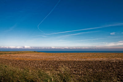 Scenic view of sea against blue sky