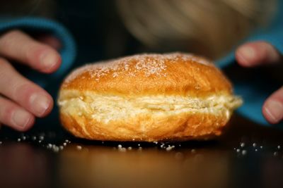 Close-up of hand holding donut