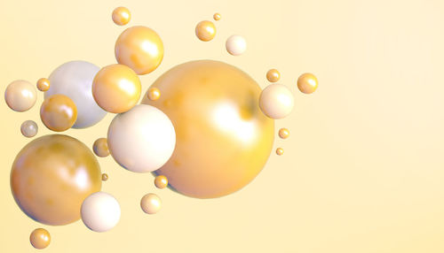 Low angle view of balloons against white background