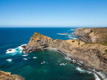 Scenic view of sea against clear blue sky