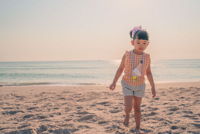 Full length of girl standing on beach