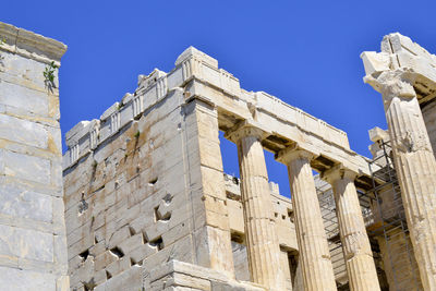 Low angle view of historic building against blue sky