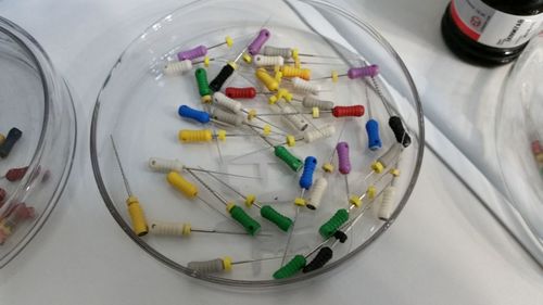 High angle view of syringes in glass plate