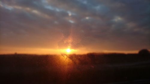 Close-up of silhouette grass against sky during sunset