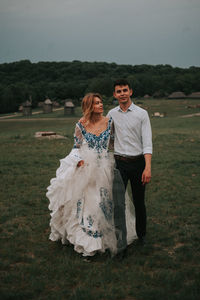 Full length of couple walking on grass