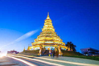 Illuminated temple against blue sky