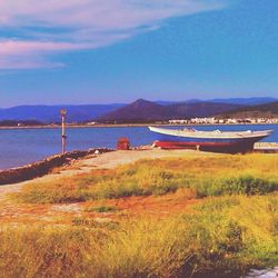 Scenic view of calm sea against mountain range