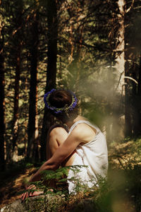 Side view of woman in forest