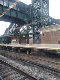 Railroad tracks by train against sky