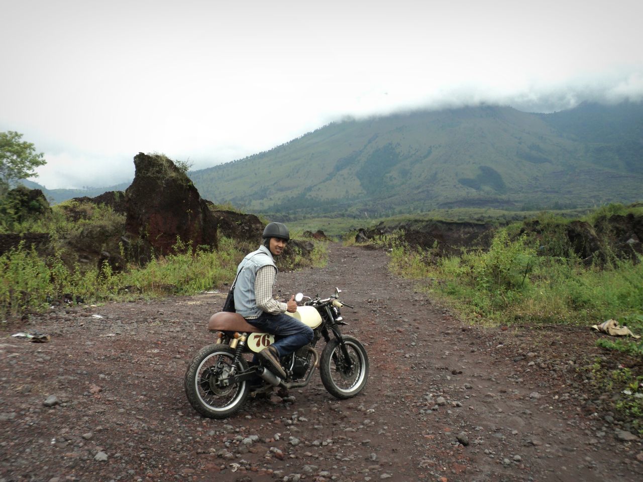 transportation, land vehicle, bicycle, mode of transport, mountain, lifestyles, riding, men, leisure activity, full length, motorcycle, road, travel, rear view, cycling, sky, mountain range, landscape