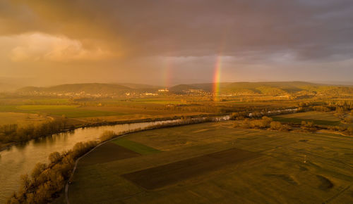 Scenic view of river against sky during sunset