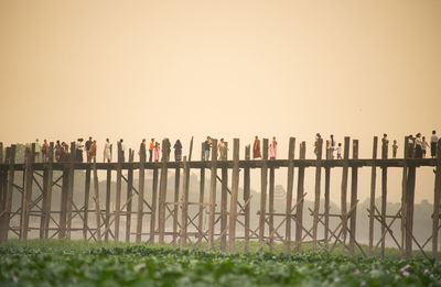 Fence on landscape against clear sky