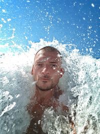 Close-up portrait of a man swimming in pool