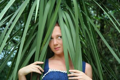 Thoughtful young woman surrounded by leaves