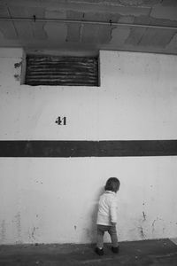 Boy standing against wall