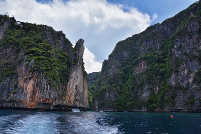 Scenic view of sea and mountains against sky