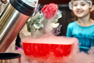 Close-up of woman holding ice cream at home