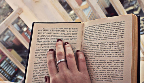 Low section of person reading book on paper