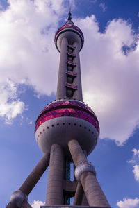 Low angle view of tower against cloudy sky