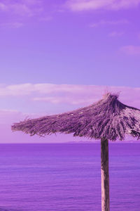 Beach umbrella and ocean view. stylish very peri creative colours wallpaper. travel concept