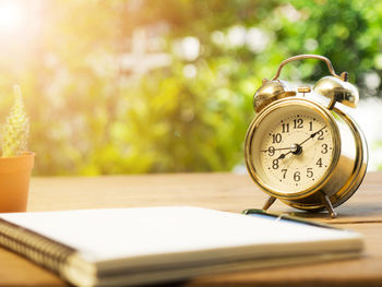 Close-up of clock on table